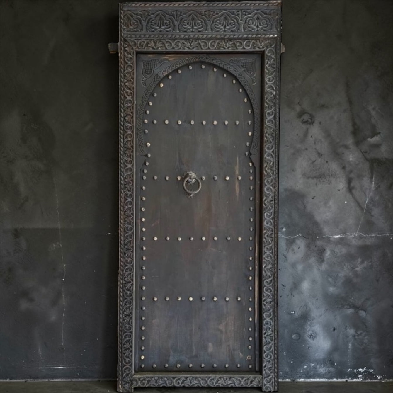 Decorative Marrakech riad door with intricate carvings and vibrant colors, showcasing traditional Moroccan craftsmanship.