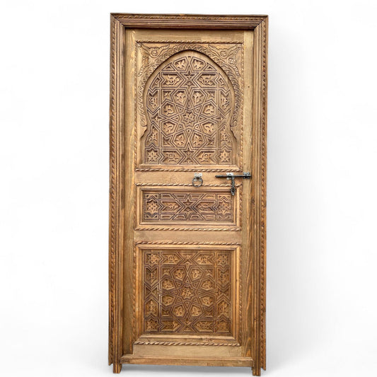 Decorative Cordoba arch door with intricate wood carvings, showcasing traditional craftsmanship and elegant design.