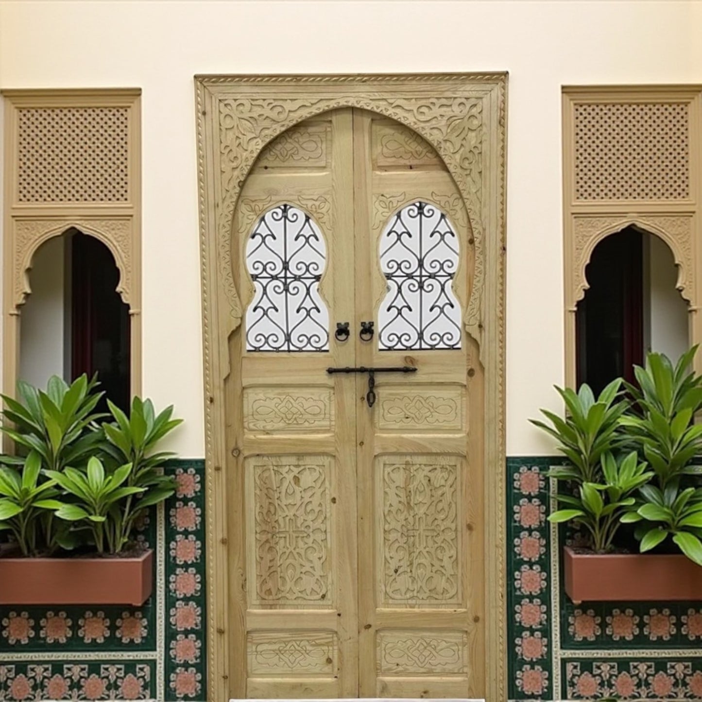 Decorative Marrakech-style wooden door with intricate carvings, featuring traditional design and warm brown finish.