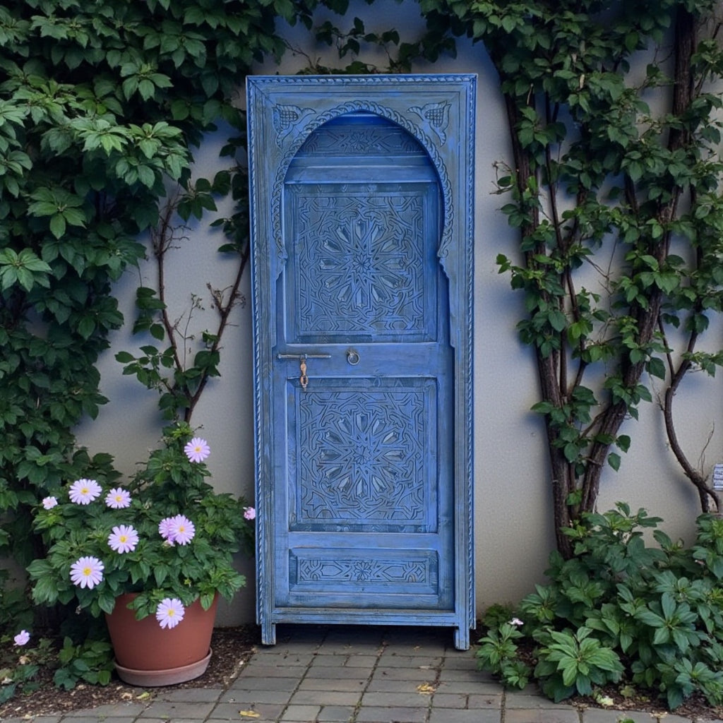 Blue Tangier door with intricate design and arched shape, showcasing vibrant color and detailed craftsmanship.