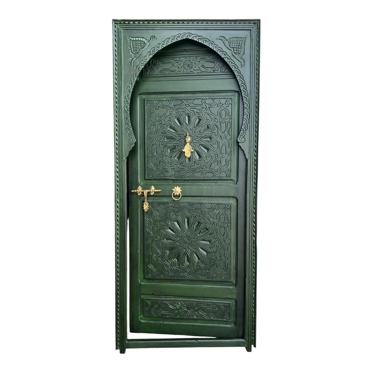 Green Andalusian door with intricate carvings and wrought iron details, showcasing traditional Spanish craftsmanship.