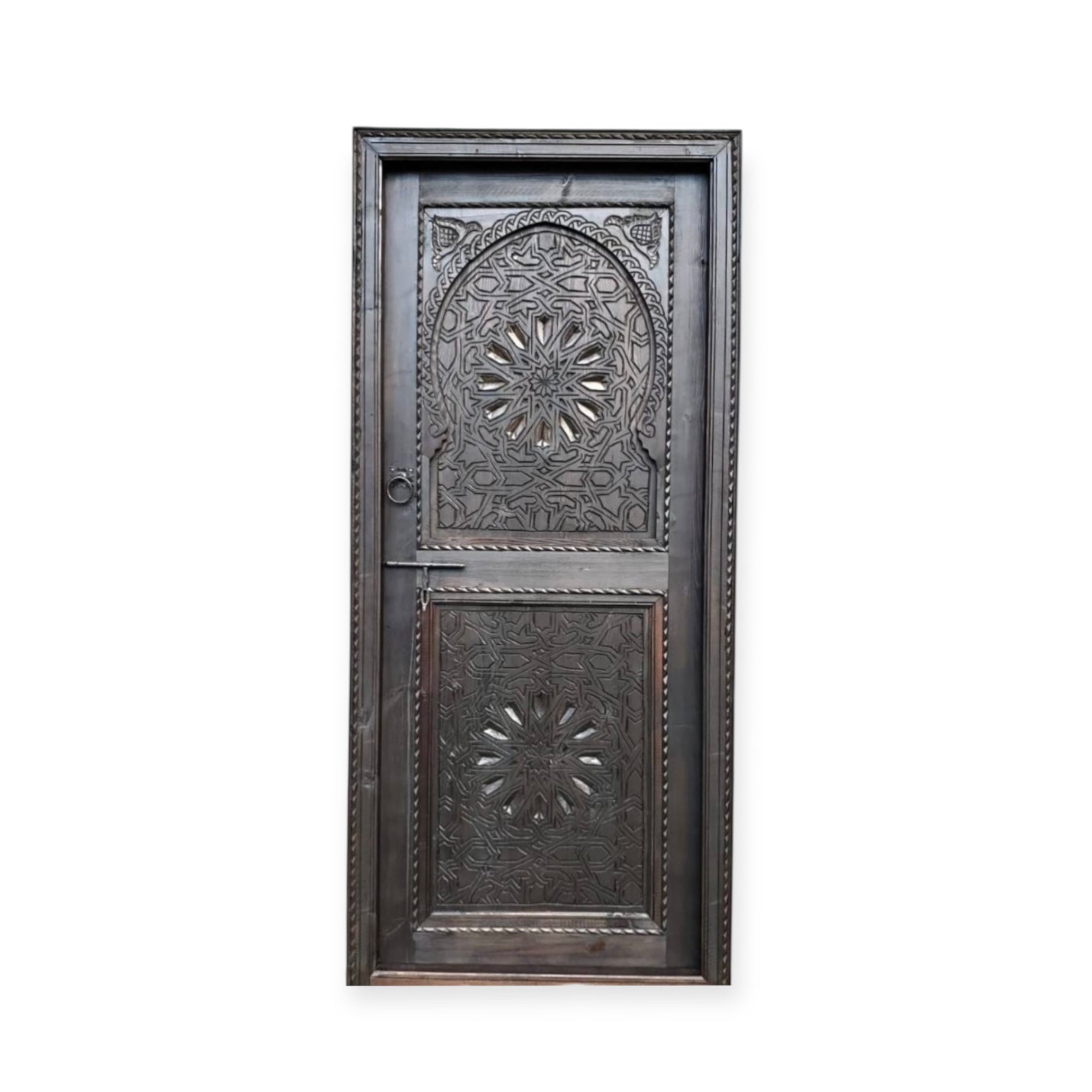 Decorative Riad door with intricate carvings and traditional design, featuring warm wood tones and detailed craftsmanship.