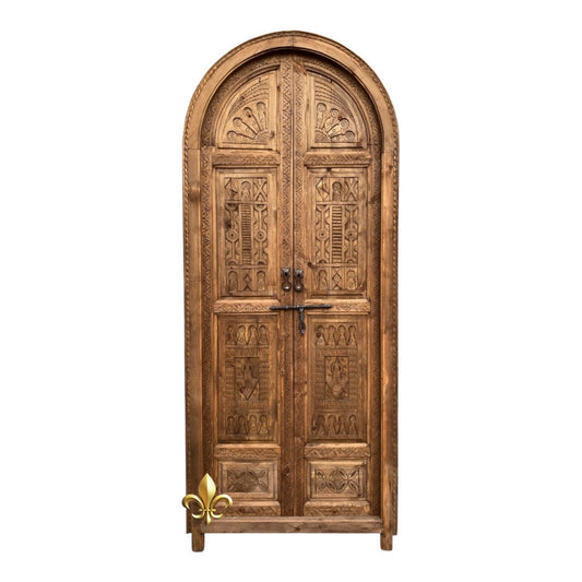 Traditional Cordoba old wooden door with intricate carvings, showcasing historic craftsmanship and rustic charm.
