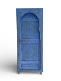 Blue Tangier door with intricate patterns and rustic finish, showcasing traditional Moroccan architectural style.