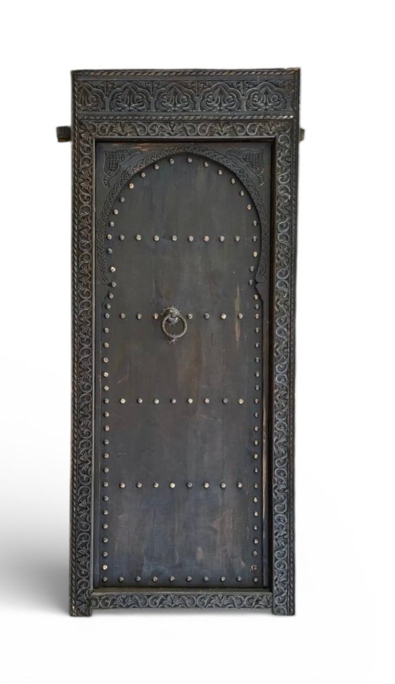 Decorative metal Moroccan door with intricate designs on a white background