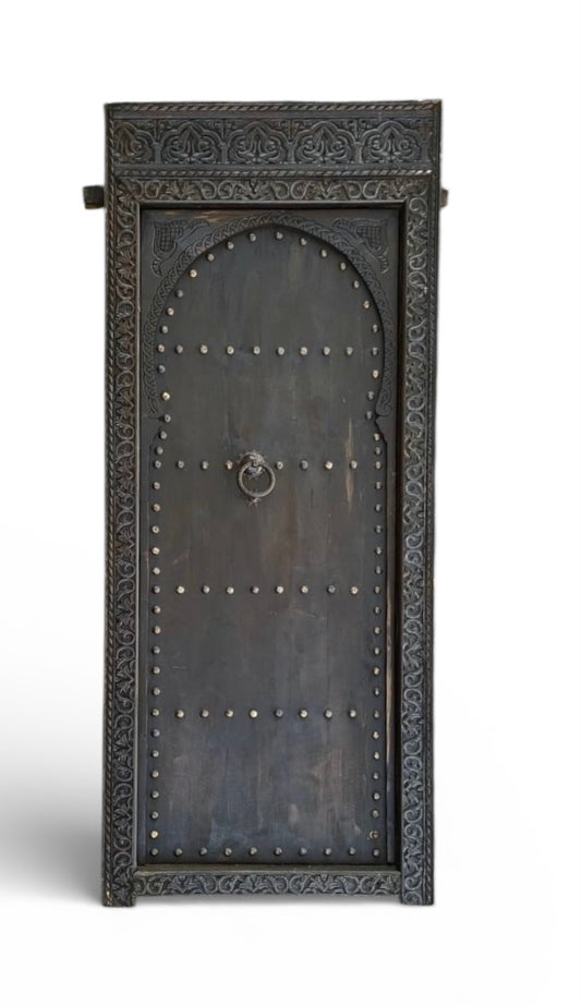 Decorative metal Moroccan door with intricate designs on a white background
