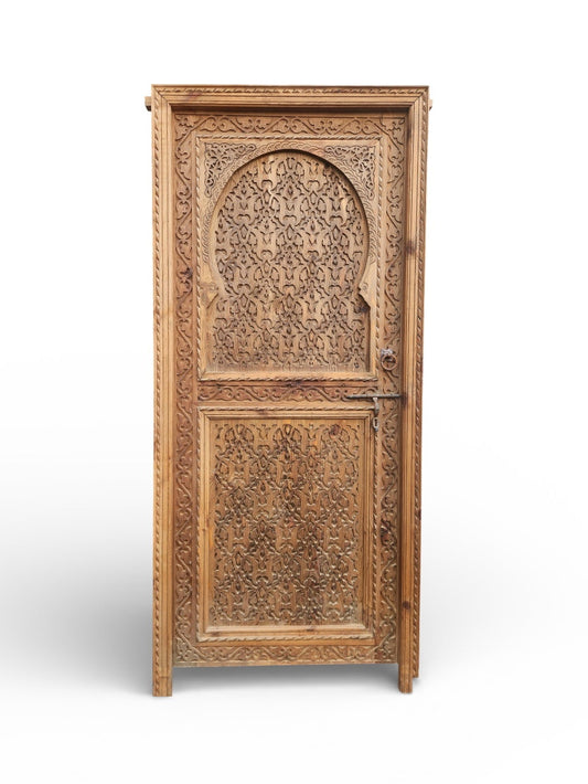 Elegant Andalusian door with intricate wood carvings and traditional design, showcasing craftsmanship and detailed craftsmanship.