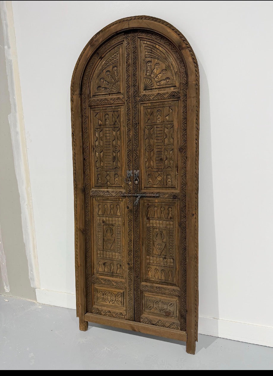 Moroccan Cordoba dark old door with intricate wood carvings and vintage design, showcasing traditional craftsmanship.