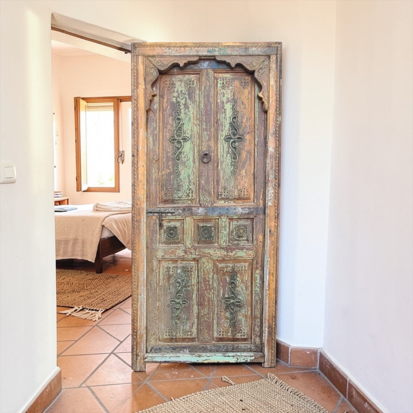 Vintage Andalus Moroccan garden door with intricate wood carvings and colorful tile accents, showcasing traditional craftsmanship.